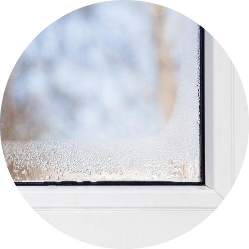 Photo of a window corner where condensation is forming to show humidity problems