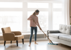 Woman sweeping clean home