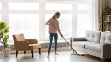 Woman sweeping clean home
